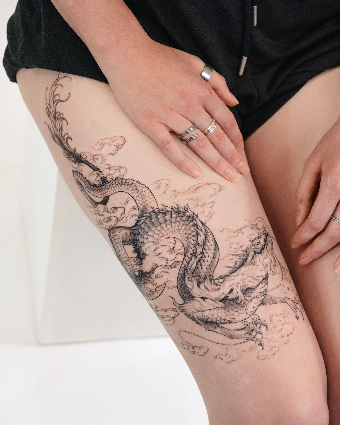 1747618674-dragon-tattoo-thigh-fineline